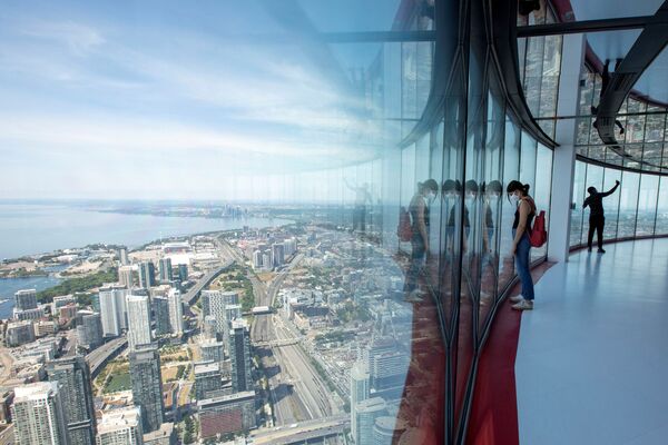 يشاهد الزائرون مشاهد المدينة البانورامية من برج سي إن الذي يبلغ ارتفاعه 553 مترًا (1815 قدمًا) ، والذي أعيد افتتاحه لأول مرة منذ فرض قيود منع المرض التاجي (كوفيد-19) في تورونتو ، أونتاريو، كندا 15 يوليو 2020. - سبوتنيك عربي