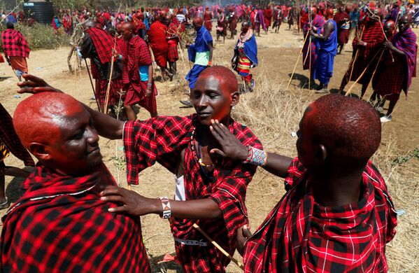 رجال قبيلة ماساي يزينون أنفسهم بصبغة حمراء قبل السير على درب أكل اللحوم، ليلتحم هناك دربين: درب الكبار إلبامو (Ilpaamu) والشباب إلايتي (Ilaitete)، أثناء احتفالات أولنغيشير (Olng'esherr) عند تلال ماباراشا، بالقرب من كاجيادو في كينيا، 23 سبتمبر 2020 - سبوتنيك عربي
