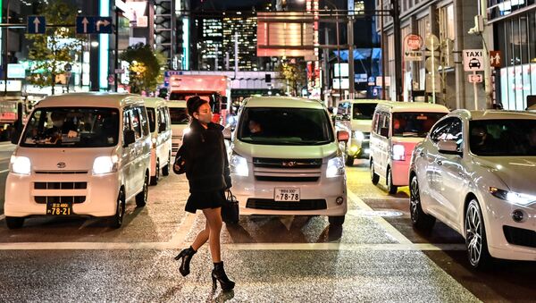 امرأة ترتدي كمامة تعبر شارعًا في طوكيو، اليابان 16 ديسمبر 2020 - سبوتنيك عربي
