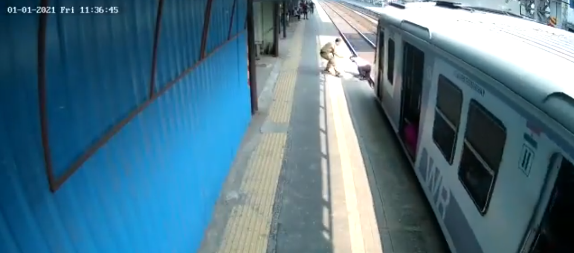 شرطي في مومباي يساعد رجلا علق على السكك الحديدية  - سبوتنيك عربي, 1920, 02.01.2021