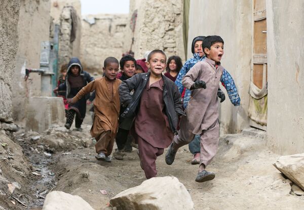 أطفال أفغانيون نازحون يلعبون بجوار ملاجئهم في ضواحي كابول، أفغانستان 3 فبراير 2021 - سبوتنيك عربي