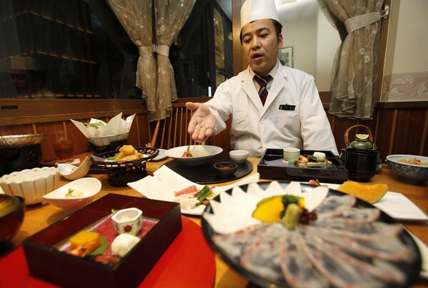 في هذه الصورة، 27 نوفمبر 2013، يشير رئيس الطهاة الياباني كينجي (47 عاماً) أود إلى قائمة الطعام في مطعم إيريمويا بيتي للأكلات اليابانية في طوكيو. - سبوتنيك عربي