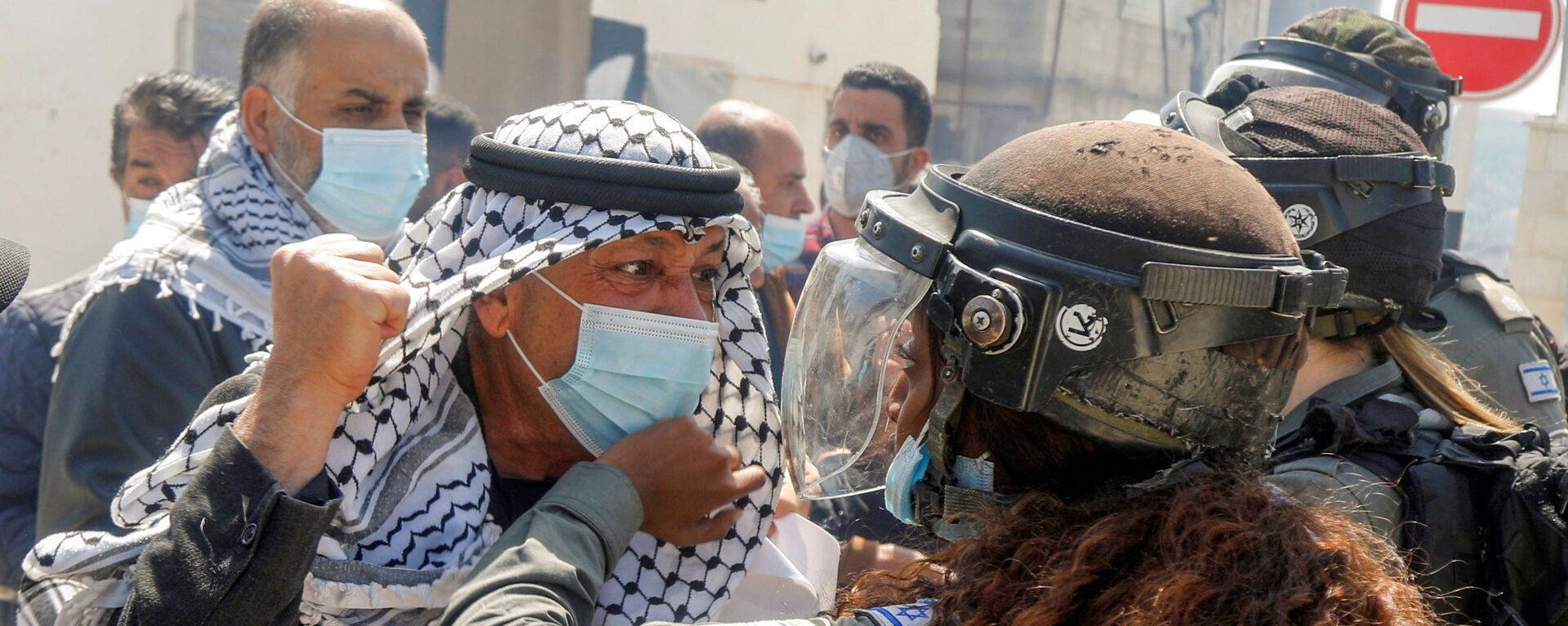 متظاهر فلسطيني يشتبك مع شرطية حدود إسرائيلية خلال مسيرة يوم الأرض، في سبسطية بالقرب من نابلس، في الضفة الغربية،  في 30 مارس 2021 - سبوتنيك عربي, 1920, 03.04.2021