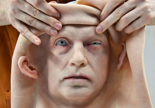 موظف يركب الجلد على رأس رجل آلي طورته شركة بروموبود لتصنيع الروبوتات، في فرع الشركة لنمذجة الروبوتات البشرية في أقصى شرق مدينة فلاديفوستوك، روسيا، 15 مارس 2021 - سبوتنيك عربي