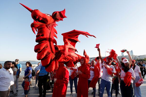 مشجعون يحملون أعلام ورموز فرق منتخبات سويسرا وويلز وتركيا أثناء استعراضهم في وسط باكو في أذربيجان، 13 يونيو 2021 - سبوتنيك عربي