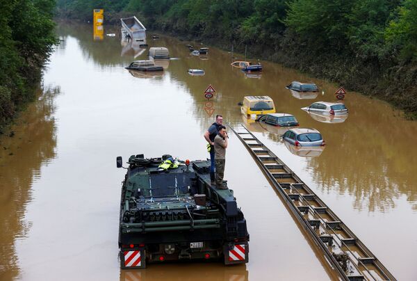 شرطي وعنصر من القوات المسلحة الألمانية يدرسون منطقة تضررت بمياه الفيضانات في إرفتشتات، ألمانيا 17 يوليو 2021 - سبوتنيك عربي