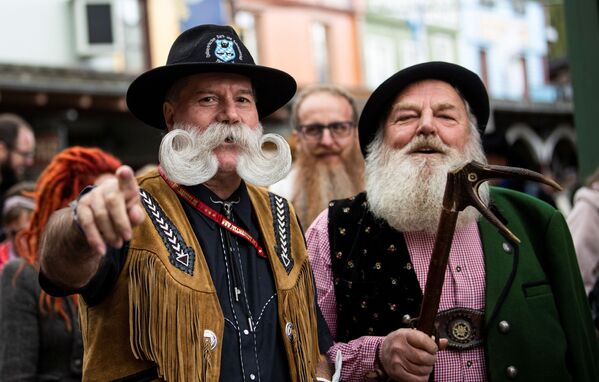 A participant and competitor Fritz Sendlhofer (R) from Austria attends the German Moustache and Beard Championships 2021 at Pullman City Western Theme Park in Eging am See, Germany, October 23, 2021. - سبوتنيك عربي