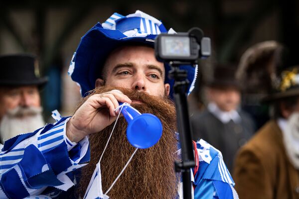 A participant arrives for the German Moustache and Beard Championships 2021 at Pullman City Western Theme Park in Eging am See, Germany, October 23, 2021.  - سبوتنيك عربي