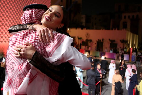 المنتج السعودي ومدير المهرجان محمد التركي يستقبل عارضة الأزياء الأمريكية ميريدث ميكلسون فور وصولها إلى حفل افتتاح الدورة الأولى لمهرجان البحر الأحمر السينمائي في مدينة جدة، السعودية، 6 ديسمبر 2021 - سبوتنيك عربي