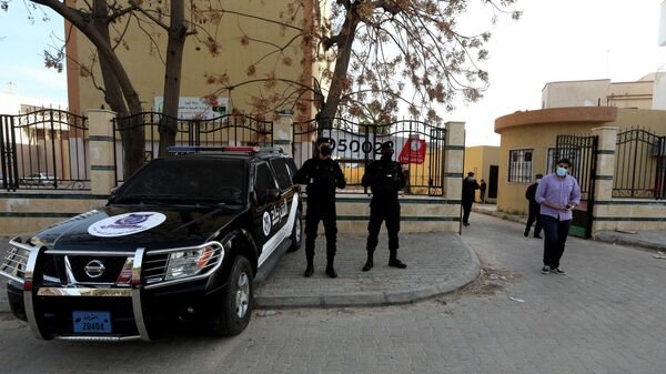 رجال الأمن الليبي يحرسون مركز اقتراع في طرابلس، ليبيا، 6 فبراير 2021 - سبوتنيك عربي