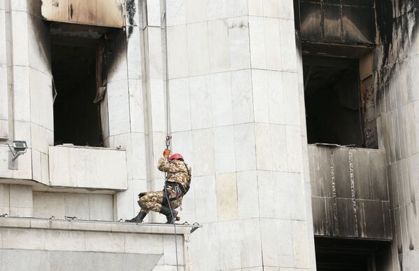 عمال أثناء أعمال ترميم مبنى رئيس البلدية أكيمات الذي دمرته النيران في ألماتي، كازاخستان 13 يناير 2021 - سبوتنيك عربي
