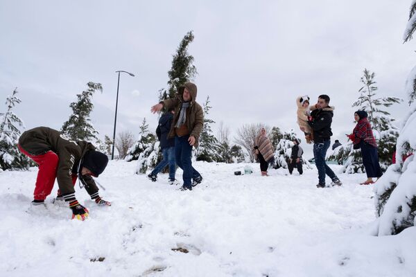 مواطنون يلعبون بالثلج في حديقة مغطاة بالثلوج في السليمانية، العراق ، 17 يناير 2022. - سبوتنيك عربي