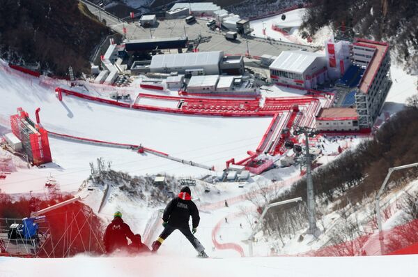 أولمبياد بكين 2022 - التزلج على جبال الألب - التزلج على المنحدرات للرجال - المركز الوطني للتزلج على جبال الألب، منطقة يانكينغ، بكين، الصين، 6 فبراير 2022. طاقم العمل الأولمبي يفحص المسار على المنحدر قبل بدء المسابقات. - سبوتنيك عربي