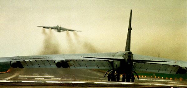 قاذفة B52 من طراز USAF على المدرج بينما تقلع أخرى من قاعدة سلاح الجو الملكي البريطاني في فيرفورد، على بعد 85 ميلاً غرب لندن يوم  29 مارس 1999 - سبوتنيك عربي