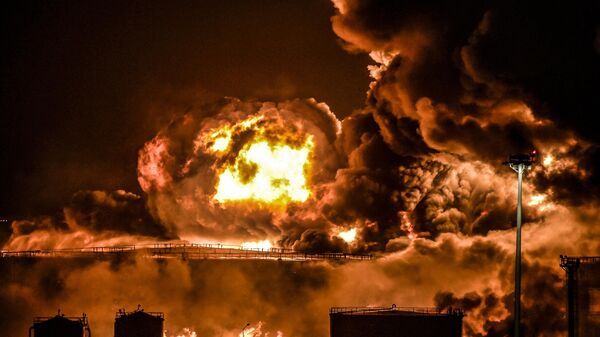 الدخان والنيران يتصاعدان من منشأة نفطية تابعة لشركة أرامكو السعودية في مدينة جدة الساحلية على البحر الأحمر في المملكة العربية السعودية في أعقاب هجوم من جماعة أنصار الله، 25 مارس/ آذار 2022 - سبوتنيك عربي