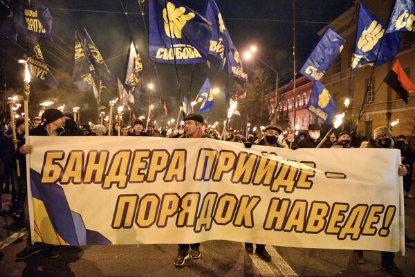 مشاركون في مسيرة بمناسبة مرور الذكرى الـ 112 لميلاد ستيبان بانديرا في كييف، 1 يناير/كانون الثاني 2021 - سبوتنيك عربي