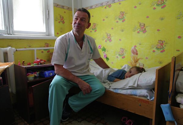 عام 2015. طبيب وطفل يتلقى العلاج في مركز الطب بمدينة غورلوفكا التابعة لمقاطعة دونيتسك. - سبوتنيك عربي