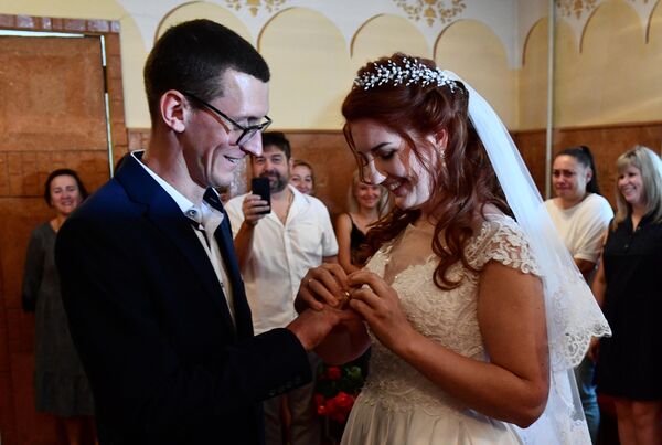 يحتفل المتزوجان حديثًا أوليغ ومارينا بزفافهما الأول منذ تحرير قرية فولودارسكو بالقرب من ماريوبول في إطار العملية العسكرية الخاصة في أوكرانيا. 28 يونيو 2022 - سبوتنيك عربي