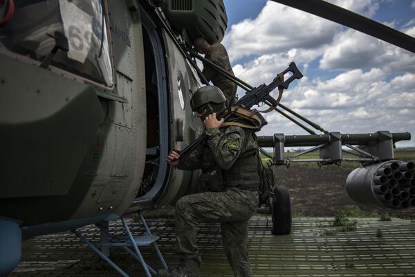 أحد جنود القوات الجوية-الفضائية يدخل مروحية مي-8 ام تي في في مطار ميداني في منطقة العملية العسكرية الخاصة في أوكرانيا - سبوتنيك عربي