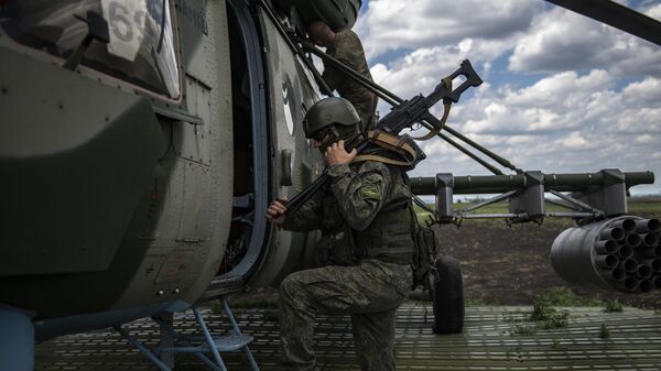 Военнослужащий у вертолета Ми-8МТВ на полевом аэродроме в зоне проведения специальной военной операции - سبوتنيك عربي