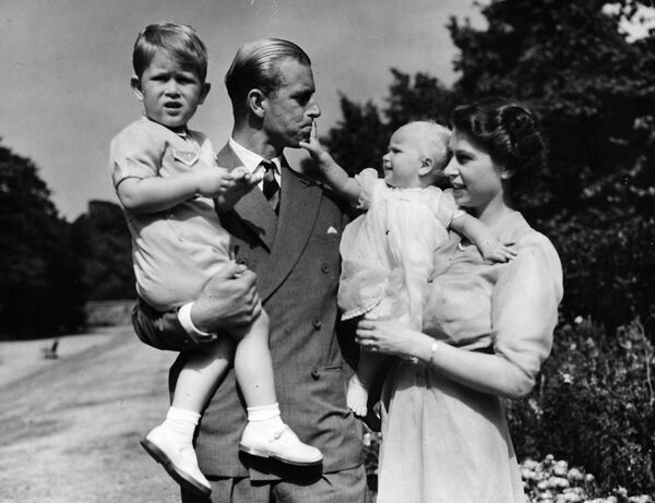 ملكة بريطانيا إليزابيث الثانية، التي كانت آنذاك الأميرة إليزابيث، تقف مع زوجها الأمير فيليب دوق إدنبرة وأطفالهما. - سبوتنيك عربي