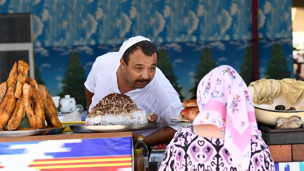 Продавец общается с женщиной на рынке в Ташкенте - سبوتنيك عربي