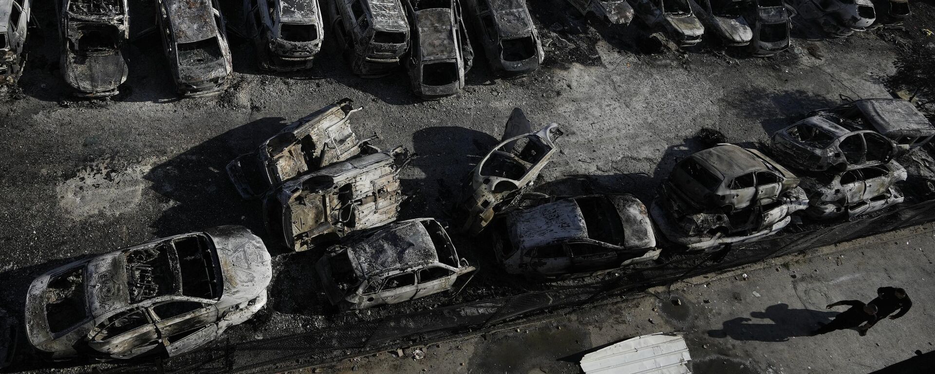 فلسطينيون يمرون بجانب سيارات محترقة في بلدة حوارة بالقرب من مدينة نابلس بالضفة الغربية، 27 فبراير 2023. - سبوتنيك عربي, 1920, 01.03.2023