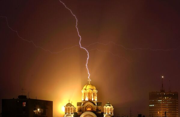 صاعقة تضرب صليبًا على كنيسة القديس مرقس خلال عاصفة رعدية في بلغراد، صربيا، يوم 29 يوليو 2006. - سبوتنيك عربي