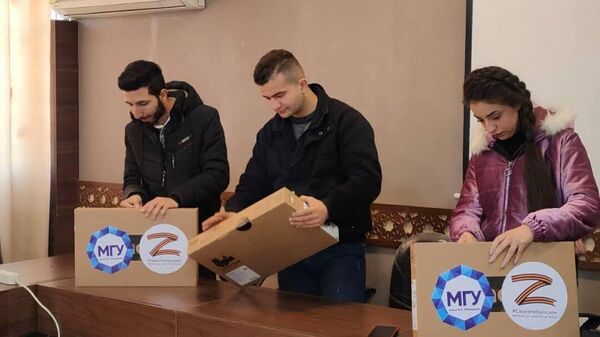 طلاب زابوروجيه يقدمون مساعدات تقنية لأقرانهم في جامعة حلب السورية - سبوتنيك عربي
