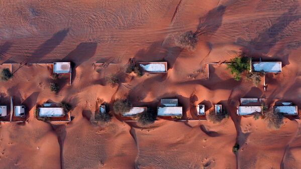 صورة جوية تظهر قرية المدام المهجورة، على الحدود مع إمارة الشارقة الخليجية، نصف مدفونة في الرمال الصحراوية، في 22 أبريل/ نيسان 2021 - سبوتنيك عربي