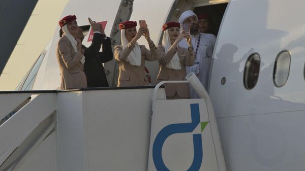 أفراد طاقم طيران الإمارات يشاهدون مظاهرة طيران في معرض دبي الجوي في دبي, الإمارات العربية المتحدة, نوفمبر. 13, 2023.  - سبوتنيك عربي