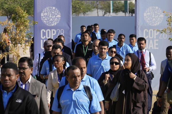يتجول الناس في مكان انعقاد قمة المناخ التابعة للأمم المتحدة في كوب 28، في دبي, الإمارات العربية المتحدة، 1 ديسمبر 2023 - سبوتنيك عربي