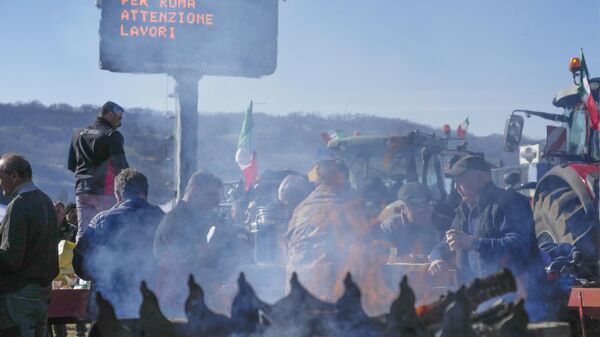يتجمع المزارعون مع جراراتهم المتوقفة بالقرب من تقاطع الطريق السريع، في أورتي، إيطاليا، 30 يناير 2024 - سبوتنيك عربي