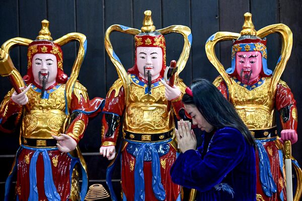 امرأة تصلي للعثور على الحب في عيد الحب في ها باغودا في هانوي في 14 فبراير 2024. - سبوتنيك عربي