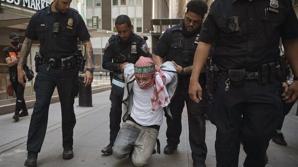 Полиция арестовывает протестующего во время пропалестинской демонстрации, возле Нью-Йоркской фондовой биржи, Нью-Йорк, США - سبوتنيك عربي