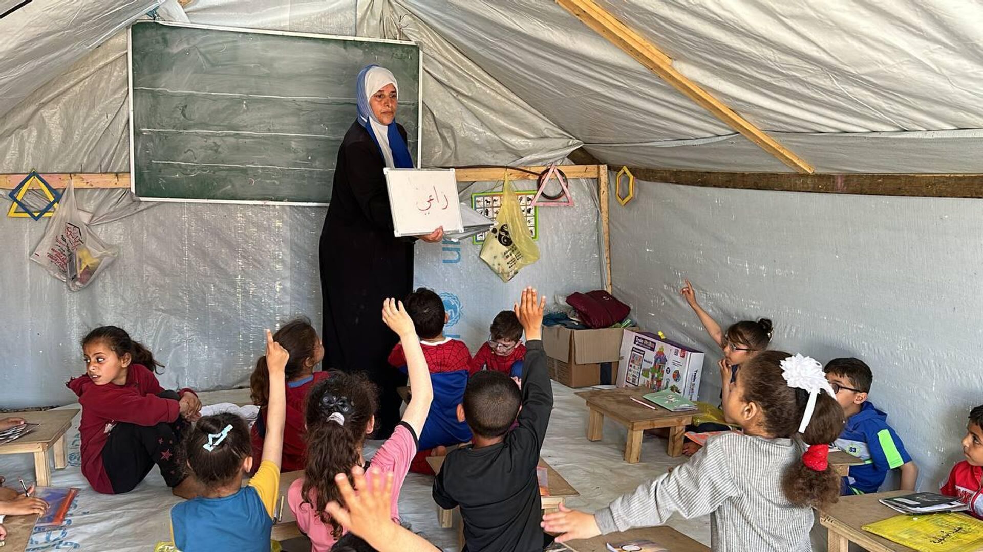 أطفال نازحون ينتزعون حقهم بالتعليم داخل خيمة بدائية في رفح جنوب قطاع غزة - سبوتنيك عربي, 1920, 18.04.2024