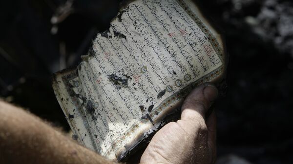 كتاب القرآن بعد الحريق - سبوتنيك عربي