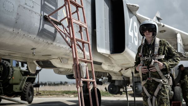 طيار القوات الجوية-الفضائية الروسية بجوار المقاتلة سو-24 في القاعدة الجوية السورية حميميم. - سبوتنيك عربي
