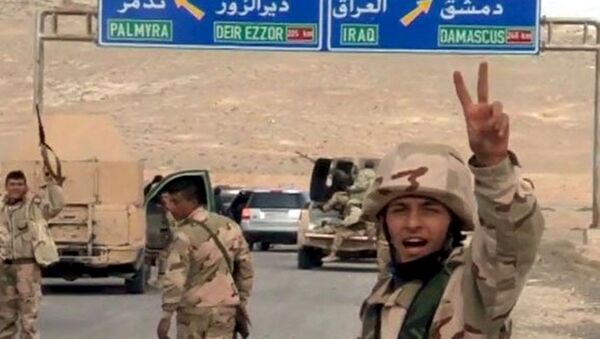 Forces loyal to Syria's President Bashar al-Assad gesture as they advance into the historic city of Palmyra in this picture provided by SANA on March 24, 2016. - سبوتنيك عربي