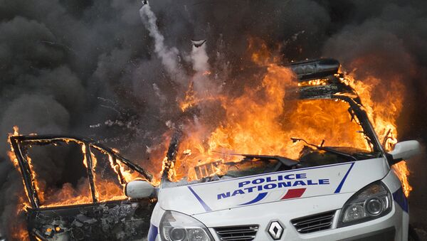 A police car explodes after being set on fire during an unauthorized counter-demonstration against police violence on May 18, 2016 in Paris, as Police across France demonstrate today against the anti-cop hatred they say they have endured during a wave of anti-government protests since early March - سبوتنيك عربي