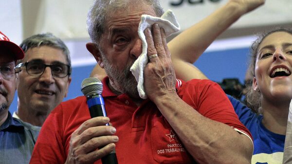 Brazilian former president Luiz Inacio Lula da Silva (C) wipes tears as he attends a meeting organized by unionists and members of the Workers Party (PT) in Sao Paulo downtown Brazil on March 4, 2016. Brazil's powerful Lula da Silva lashed out at prosecutors Friday after he was briefly detained by police as part of a probe into a massive corruption scheme - سبوتنيك عربي