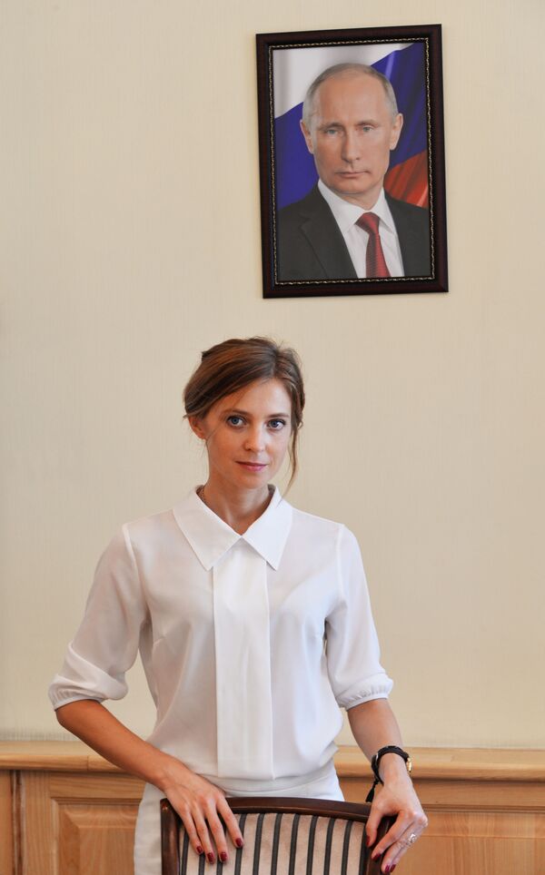 المدعي العام لجمهورية القرم نتاليا بوكلونسكايا على خلفية صورة للرئيس فلاديمير بوتين - سبوتنيك عربي