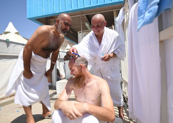 الحجاج الروس يقومون بقص شعرهم أثناء تأديتهم لمناسك الحج في مكة - سبوتنيك عربي