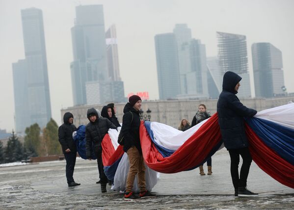 مشاركون روس في فعالية عرض أكبر علم روسيا الاتحادية في حديقة بارك بوبيدا في موسكو - سبوتنيك عربي