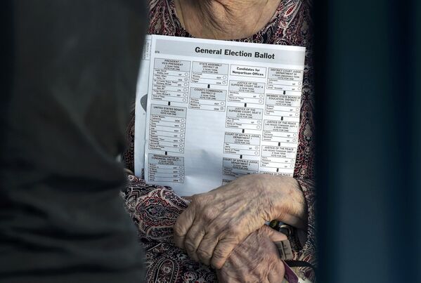 الانتخابات الرئاسية الأمريكية - امرأة تحمل ورقة التصويت في مدرسة بلاس فيغاس في نيفادا، 8 نوفمبر/ تشرين الثاني 2016 - سبوتنيك عربي