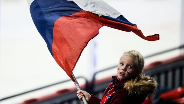 فتاة صغيرة تحمل العلم الروسي خلال المرحلة الأولى لمباراة الهوكي بين روسيا والتشيك ضمن بطولة كأس كاريالا لعام 2016/ 2017 - سبوتنيك عربي
