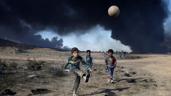 أطفال يلعبون كرة القدم في القيارة جنوبي الموصل، العراق 23 نوفمبر/ تشرين الثاني 2016 - سبوتنيك عربي
