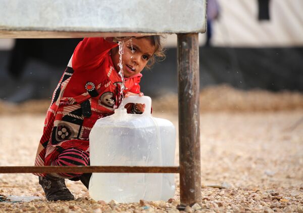 طفلة عراقية لاجئة من مدينة الموصل، تحمل وعاء لتعبئته بمياه الشرب، مخيم للاجئين بالحسكة، سوريا 5 ديسمبر/ كانون الأول 2016 - سبوتنيك عربي
