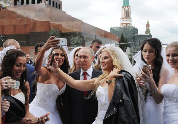 الفتيات تلتقطن صورة جماعية مع الرئيس فلاديمير بوتين خلال افتتاح مراسم عيد المدينة (موسكو) في  الساحة الحمراء - سبوتنيك عربي