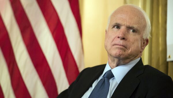 Sen. John McCain, R-Ariz., listens as Republican presidential candidate Lindsey Graham speaks defending McCain's military record during a town hall meeting at the 3 West Club to launch Graham's “No Nukes for Iran” tour Monday, July 20, 2015, in New York - سبوتنيك عربي